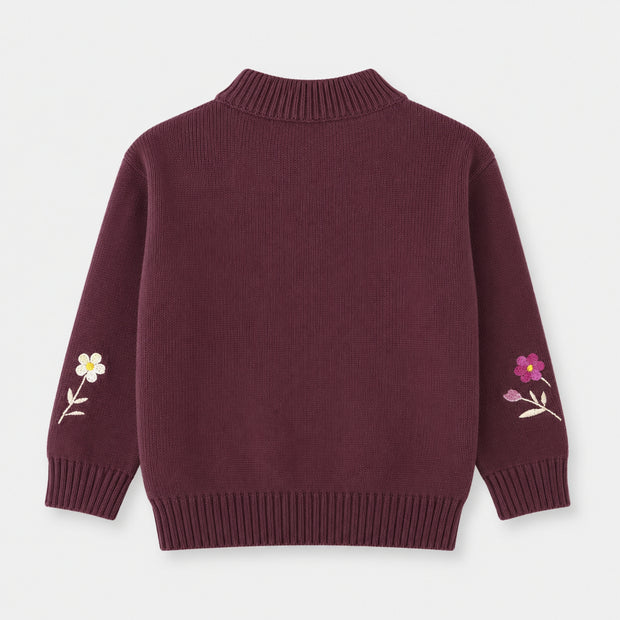 Back view of the girls deep-plum cotton sweater, showing a plain finish, floral embroidery on both sleeves and a ribbed mock neckline.