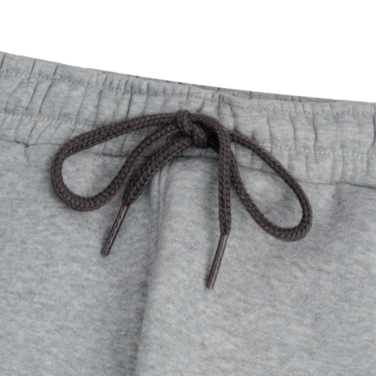 Close-up of the elasticated waistband and charcoal braided drawstring on the boys’ heather grey color block joggers.
