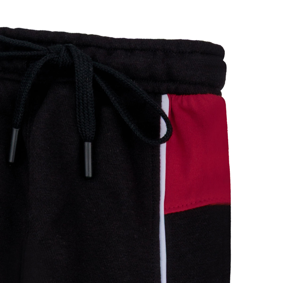 Close-up of the black elasticated waistband, matching drawstring, maroon color block panel and white piping on the boys terry joggers.