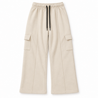 Front view of boys and girls cream terry cargo trousers with wide-leg fit, side flap pockets and black drawstring waist
