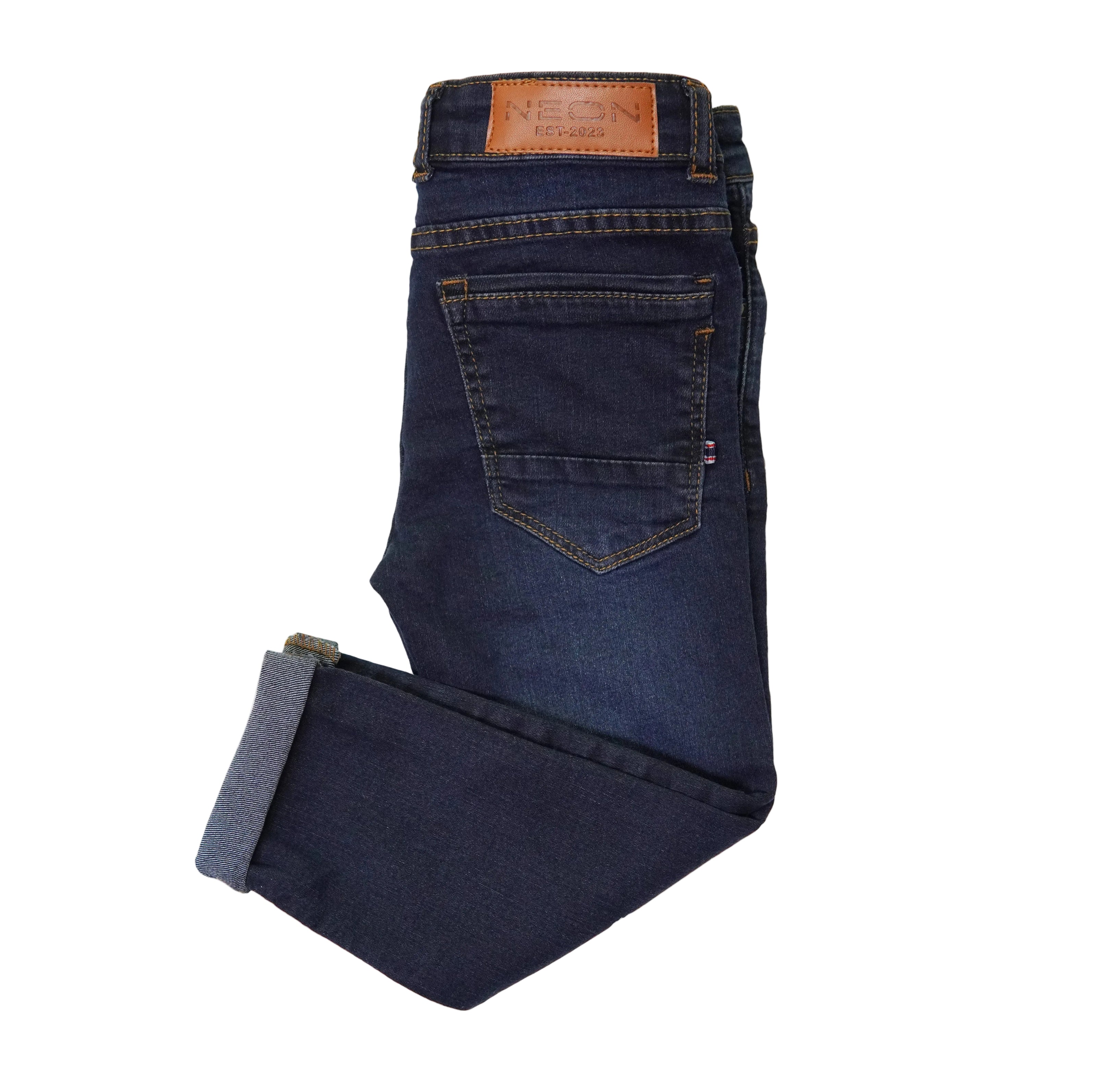 Back view of the kids deep indigo denim showing the back pocket, cuffed hem, contrast stitching and branded waist patch.