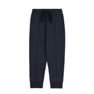 Navy blue fleece joggers for boys with an elasticated waistband, matching drawstring, front pintuck seams and ribbed ankle cuffs.