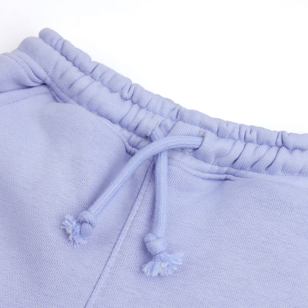 Close-up of the elasticated waistband and matching drawstring on the kids’ lavender fleece joggers.