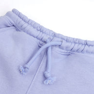 Close-up of the elasticated waistband and matching drawstring on the kids’ lavender fleece joggers.