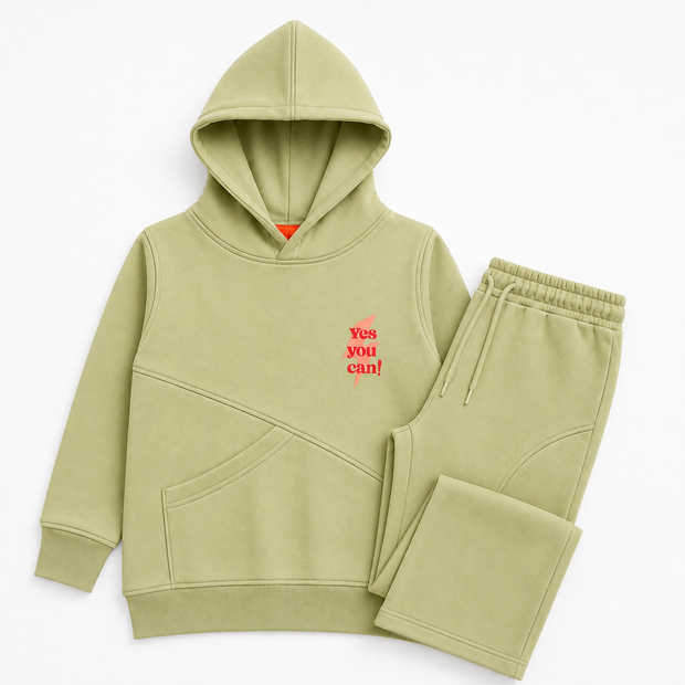 Complete view of the girls pistachio-green fleece co-ord set featuring a Yes You Can graphic hoodie with matching wide-leg trousers.