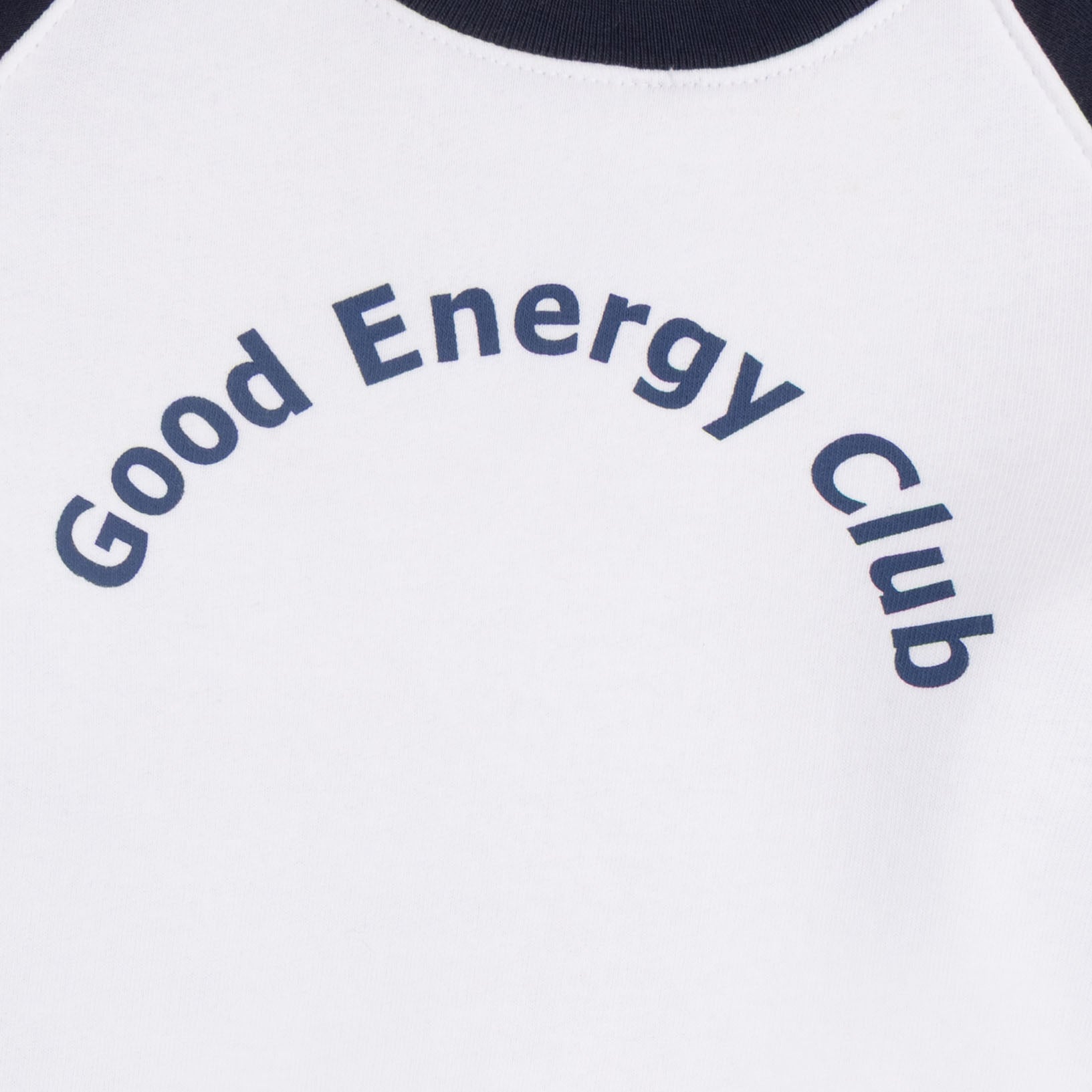Close-up of the navy Good Energy Club graphic printed across the chest of the kids’ white fleece sweatshirt.