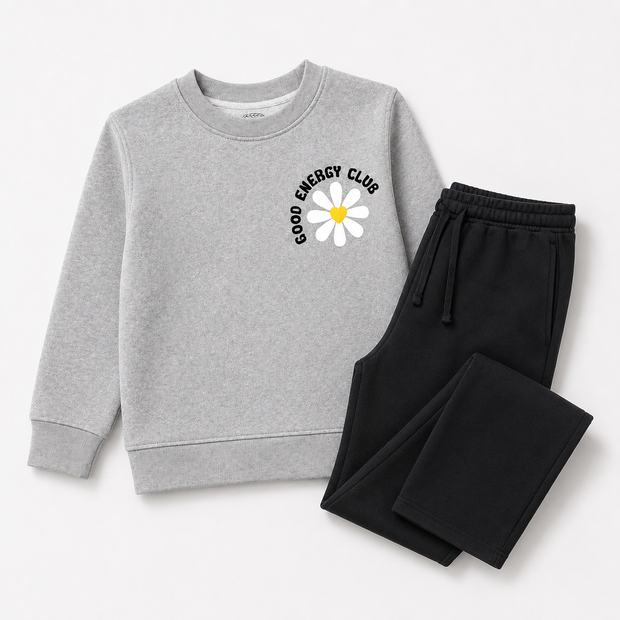 Complete view of the girls fleece co-ord set featuring a grey Good Energy Club daisy sweatshirt with black wide-leg drawstring trousers.