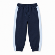 Front view of boys navy fleece joggers featuring light-blue side stripes, side pockets, a drawstring waist and elasticated ankle cuffs.