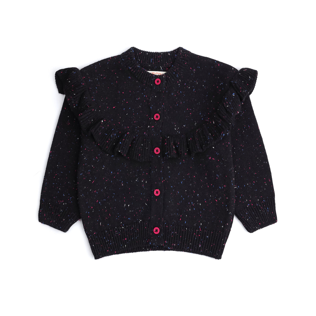 Front view of a black cotton cardigan for girls, featuring multicolor speckles, a statement ruffle across the shoulders and front, pink buttons and ribbed edges.