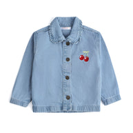 Front view of the girls light-blue denim jacket featuring red cherry embroidery, a ruffled collar, long sleeves and an antique-bronze button-down front.
