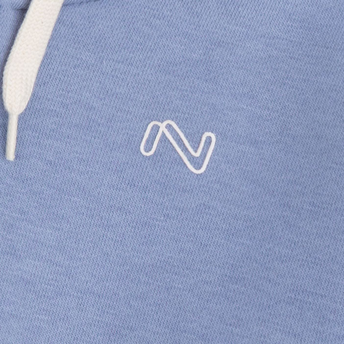 Close-up of the white embroidered chest logo and matching drawstring on the sky blue fleece zip-up hoodie for kids.