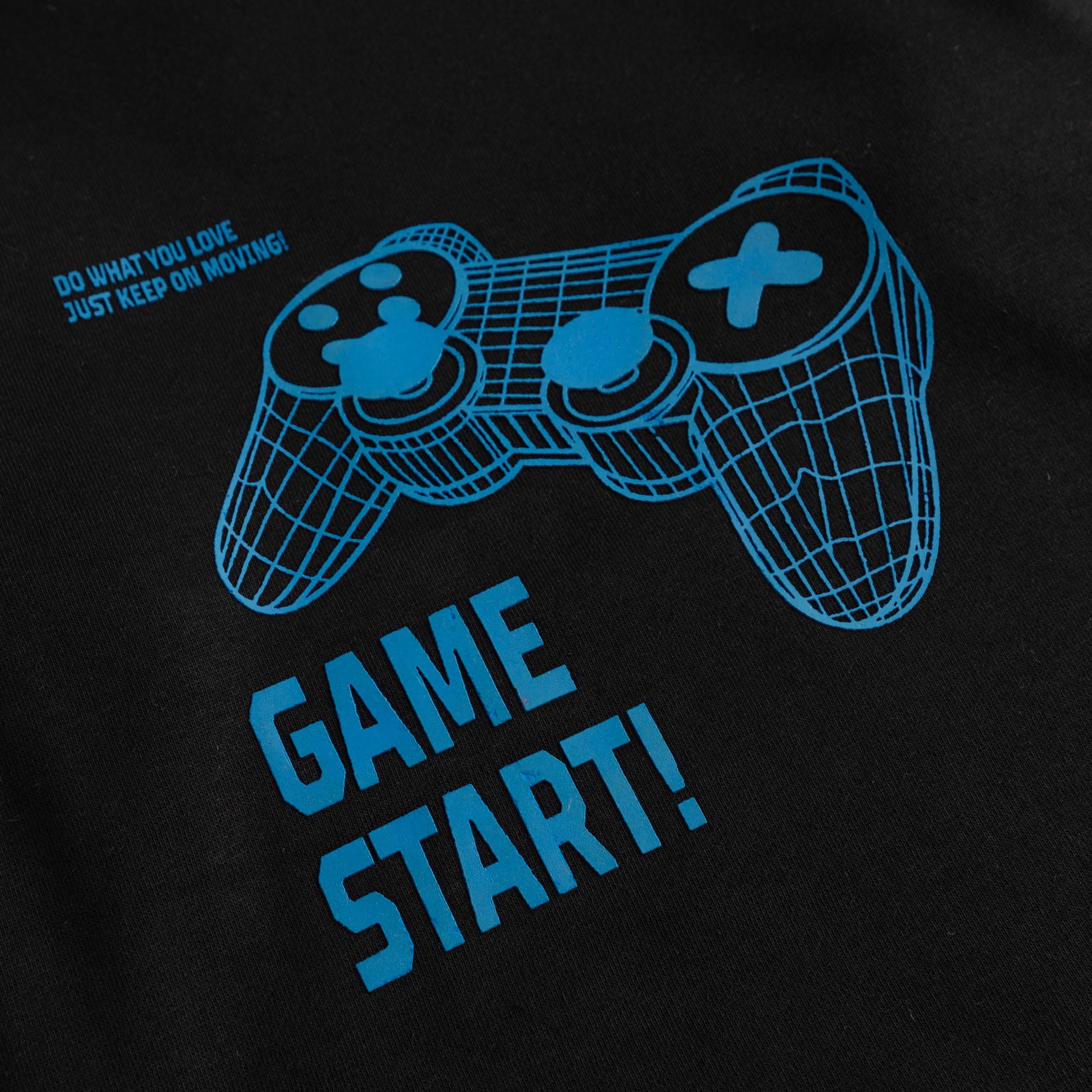 Close-up of the electric blue gaming controller and Game Start graphic printed on the boys’ black fleece sweatshirt.