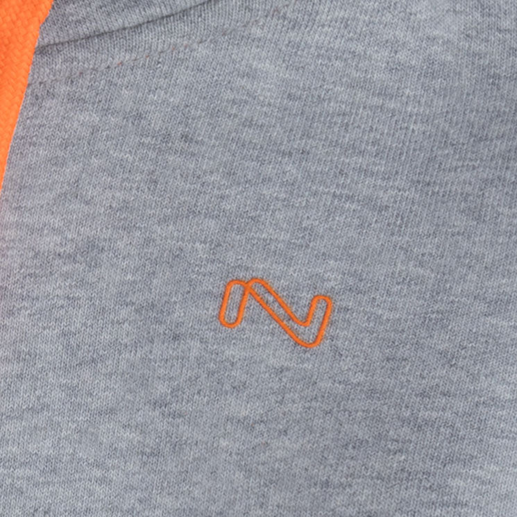 Close-up of the orange embroidered chest logo and matching drawstring on the heather grey fleece zip-up hoodie for kids.
