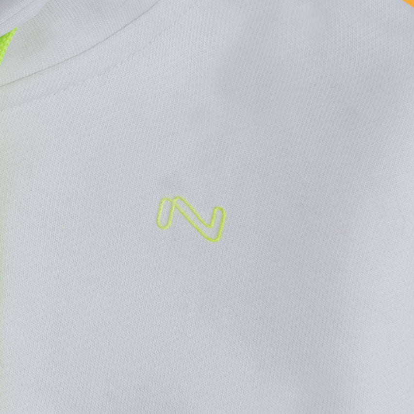 Close-up of the neon green embroidered chest logo on the white fleece zip-up hoodie for kids.