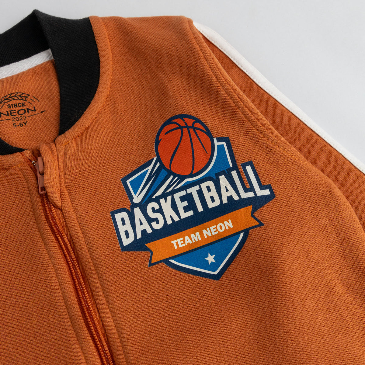Basketball Team Neon chest graphic on rust orange bomber jacket