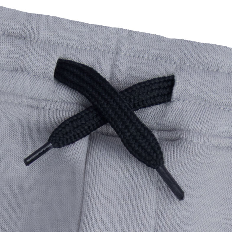 Close-up of the elasticated waist and black drawstring with coated tips on the light grey boys cargo joggers.