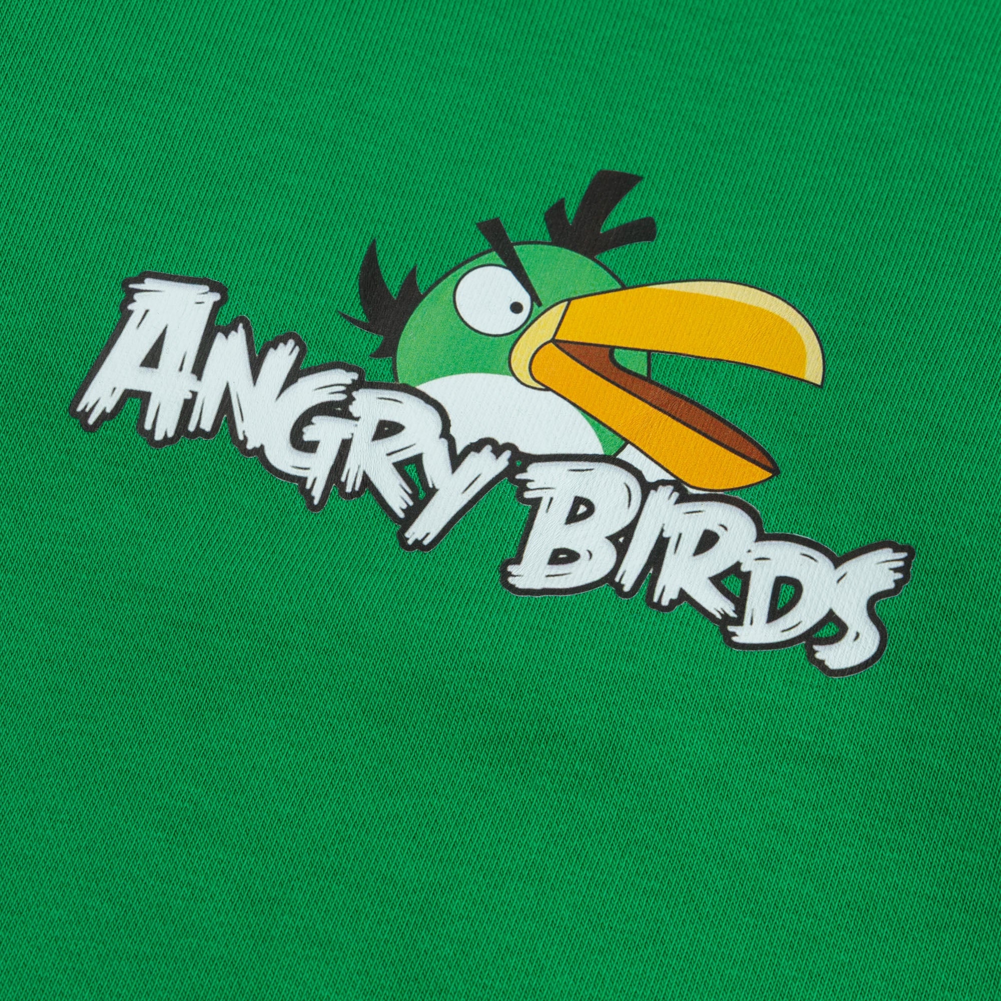 Close-up view of the Angry Birds character and logo graphic in white, black, yellow and orange on a green fleece sweatshirt for boys.