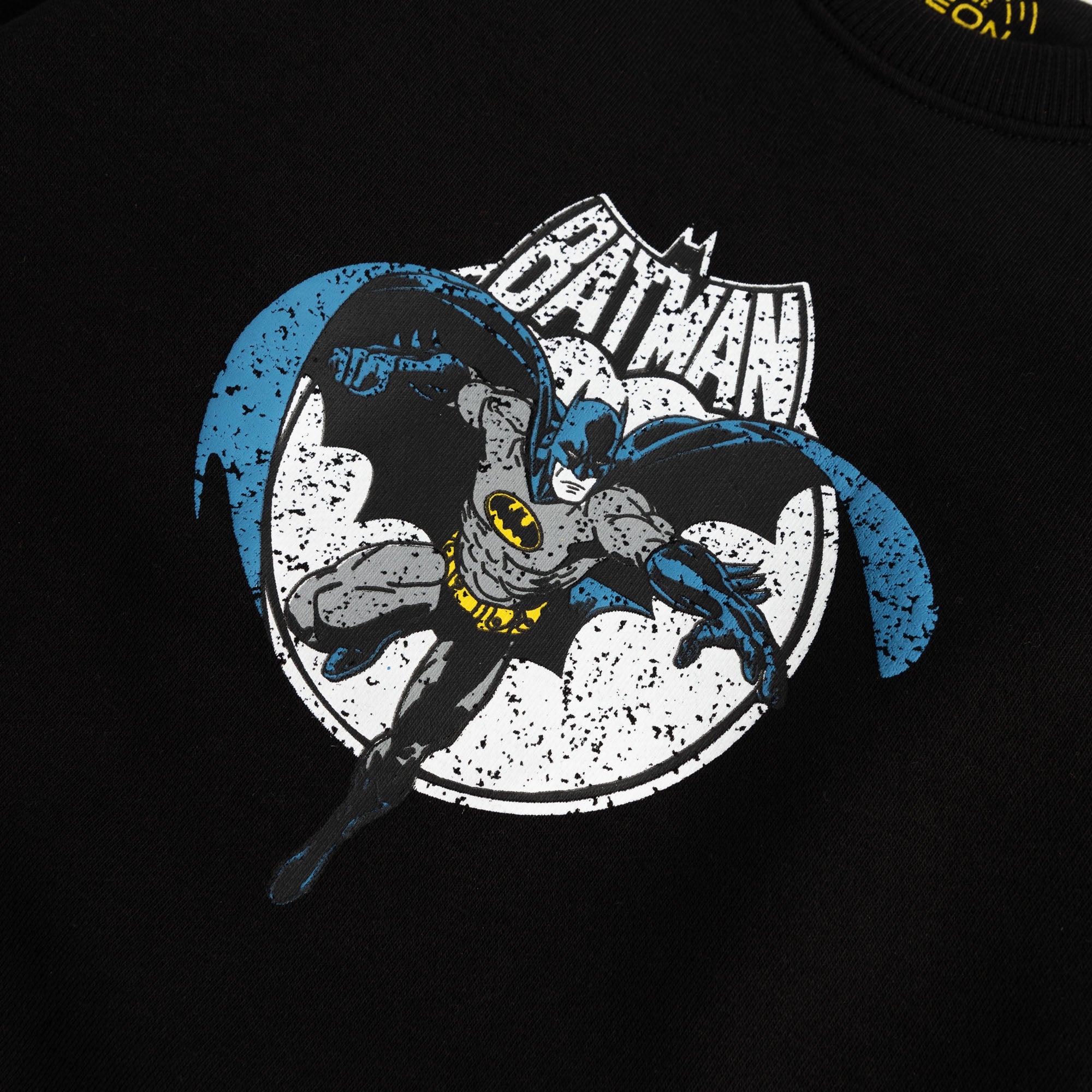 Close-up view of the graphic in blue, grey, white and yellow on a black fleece sweatshirt for boys.