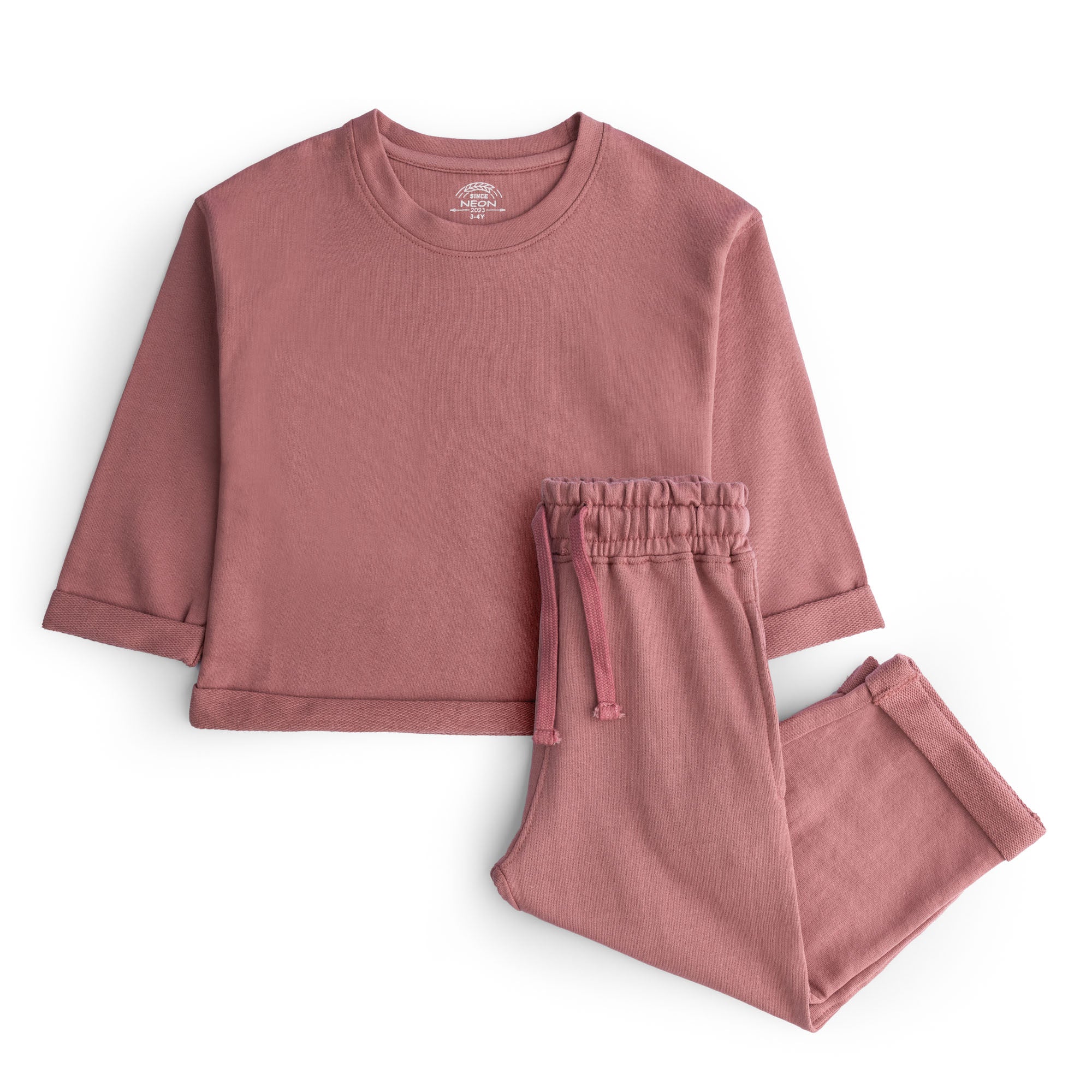 Girls dusty rose terry co-ord set featuring a plain crew neck top with folded cuffs and matching straight-leg drawstring trousers.