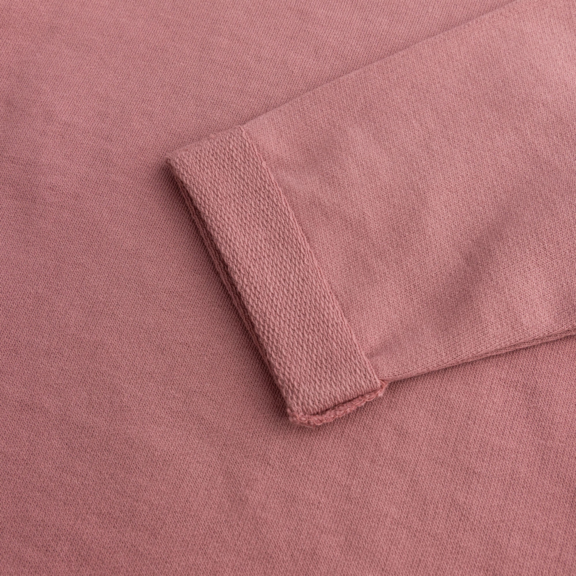 Close-up view of the soft dusty rose terry fabric and neatly folded sleeve cuff of the girls two-piece co-ord set.