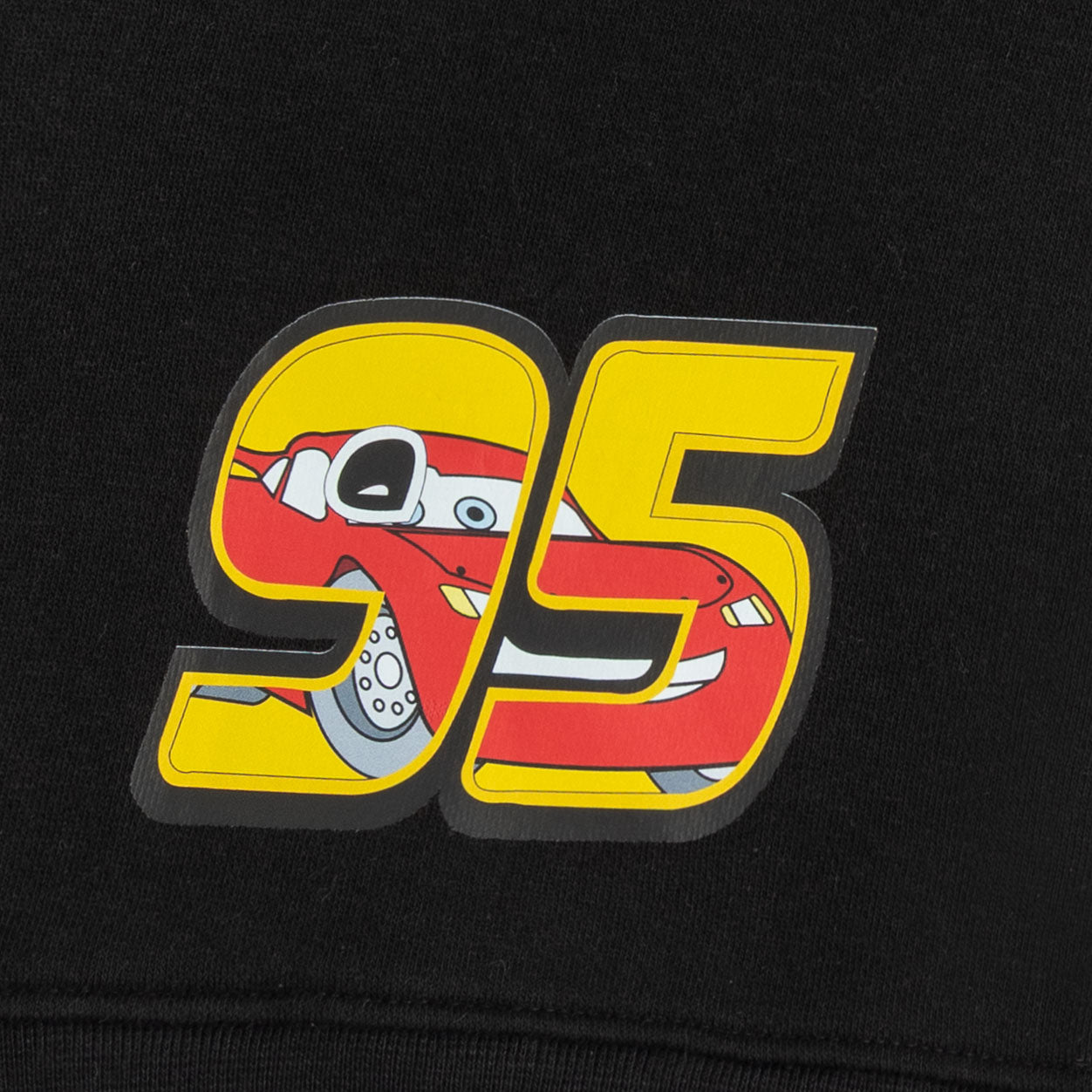 Close-up of the yellow and red number 95 racing car graphic printed on the black sweatshirt.