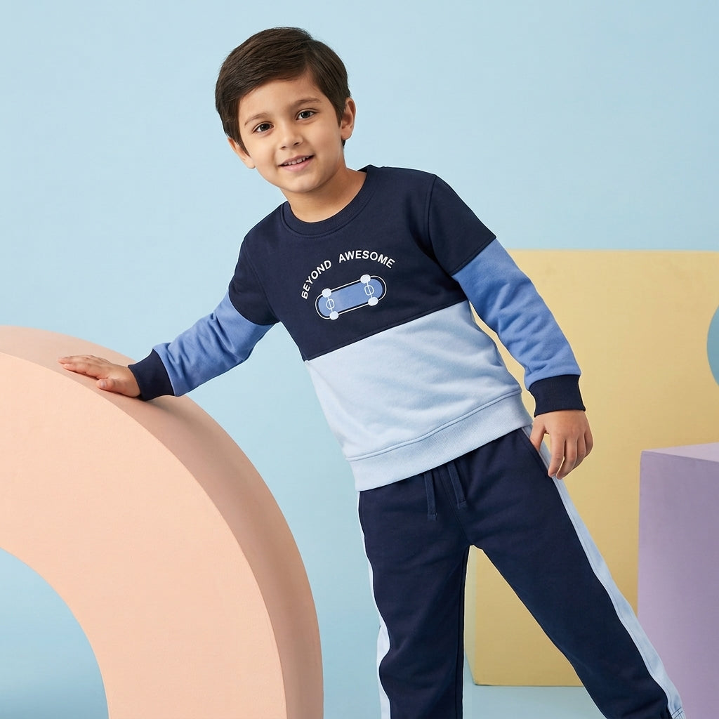 Boy wearing a navy and light-blue Color Block Co-ord Set featuring a skateboard graphic sweatshirt and matching side-stripe joggers.