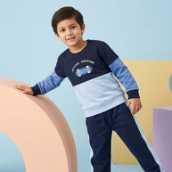 Boy wearing a navy and light-blue Color Block Co-ord Set featuring a skateboard graphic sweatshirt and matching side-stripe joggers.